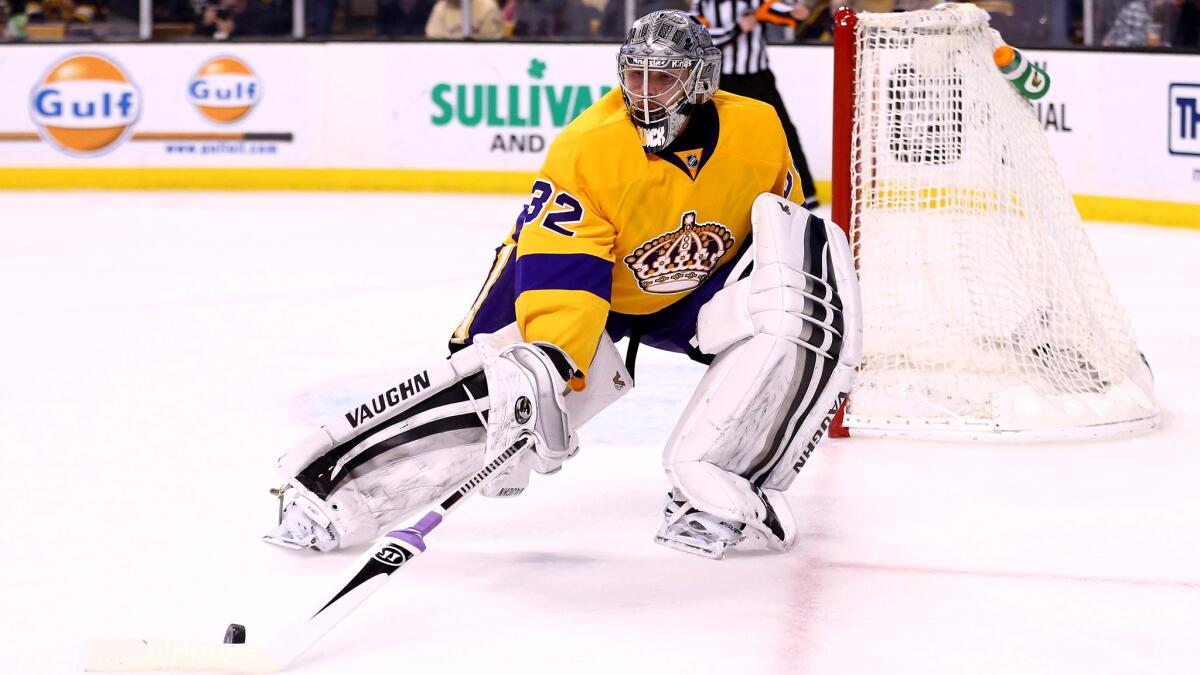 Kings goaltender Jonathan Quick retrieves the puck during a game against the Bruins on Feb. 9.