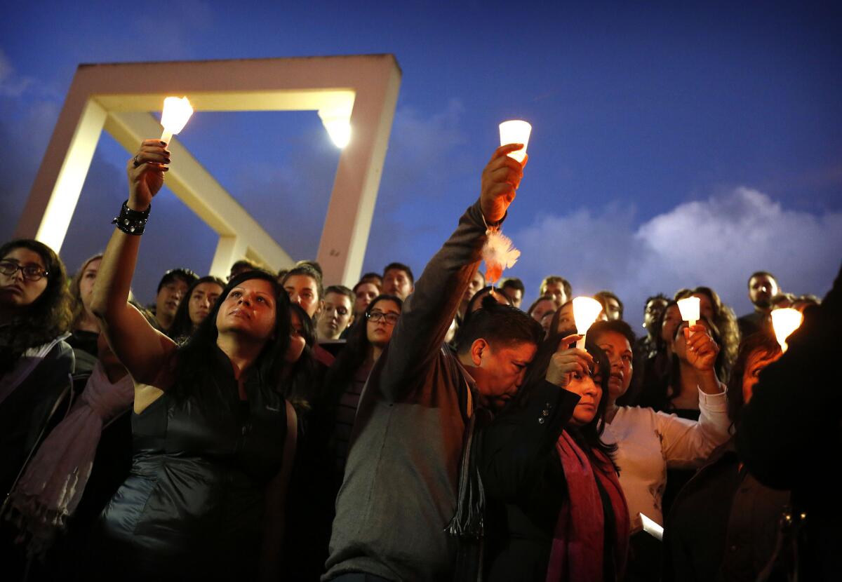 The mother (foreground, pink scarf) and stepfather of Paris terror attack victim Nohemi Gonzalez join the crowd at a Cal State Long Beach memorial service on Nov. 15.