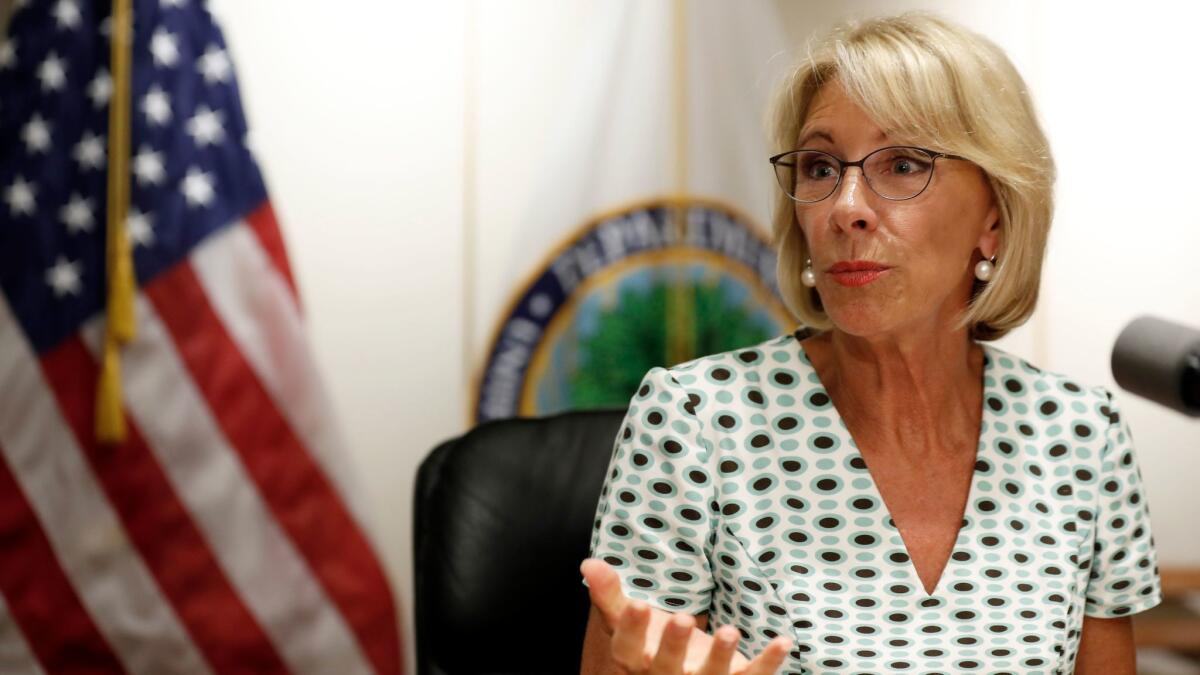 Education Secretary Betsy DeVos speaks with the media after a series of listening sessions about campus sexual violence in July in Washington.