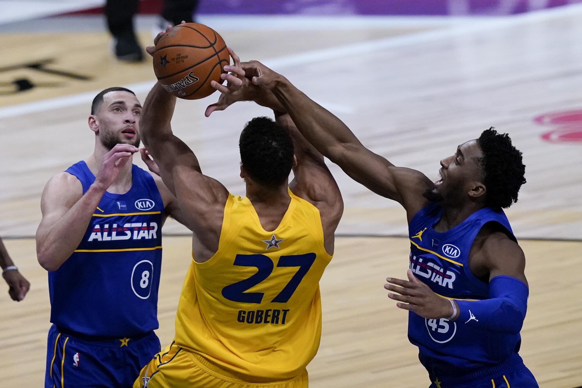 Jazz guard Donovan Mitchell of Team Durant blocks a shot by Utah teammate Rudy Gobert of Team LeBron.