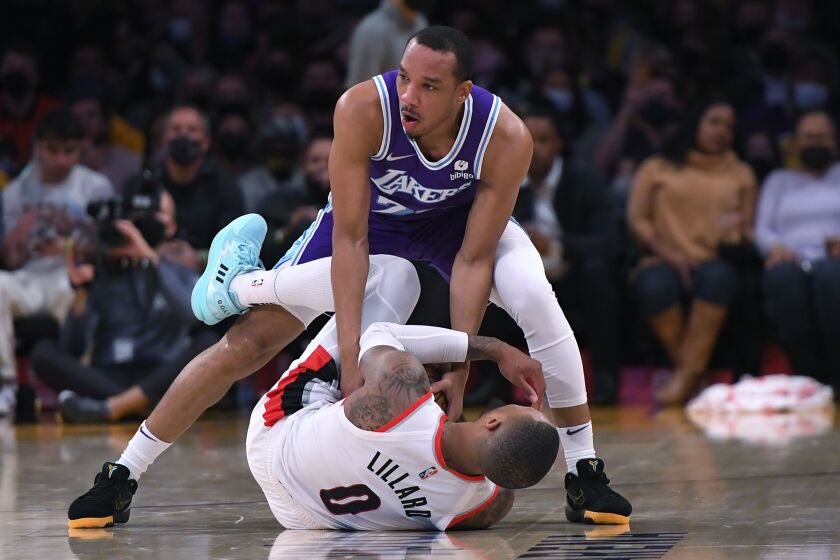 The Lakers' Avery Bradley tries to snag the ball from Portland's Damian Lillard during Friday's game.