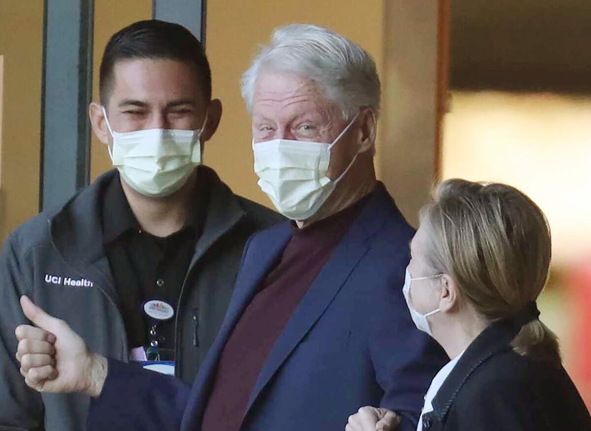Former President Bill Clinton, standing with his wife, Hillary, was discharged from UC Irvine Medical Center Sunday.