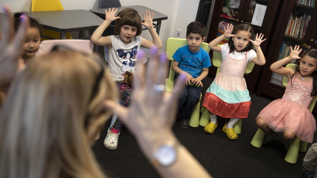 The daughter of Los Angeles Times reporter Esmeralda Bermudez takes part in her weekly French class. The 5-year-old, in yellow shoes, told her parents she wanted to learn French so she could chat with her imaginary French friend, a redheaded boy named Dohmerrish.