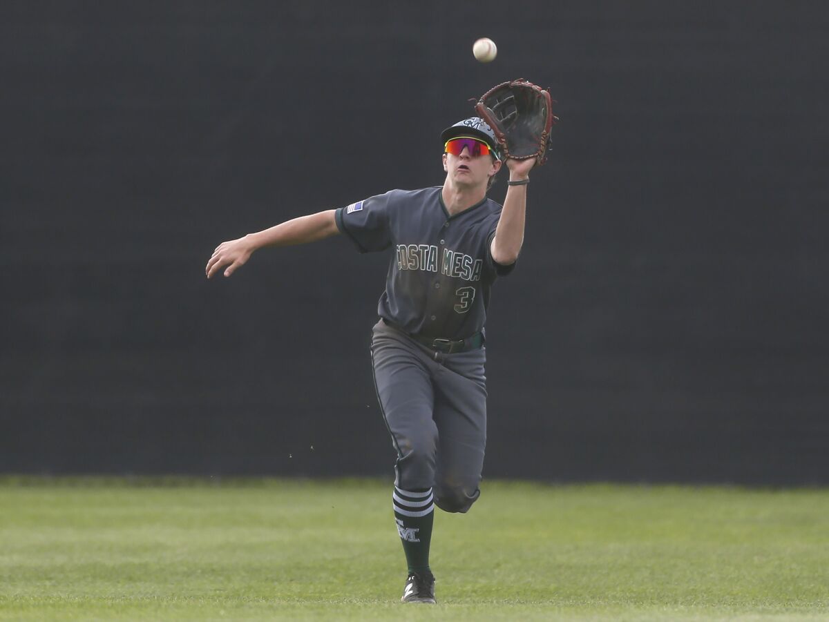 Costa Mesa's Aiden Comte makes a running catch in the outfield during Friday's game.