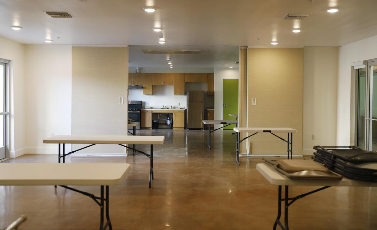 The community room is shown during a tour of 88th and Vermont.