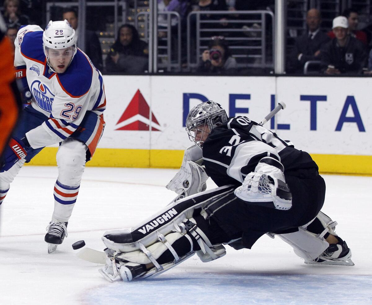 Kings goalie Jonathan Quick (32) blocks a shot by Oilers forward Leon Draisaitl (29)during the first period of a game on March 26.