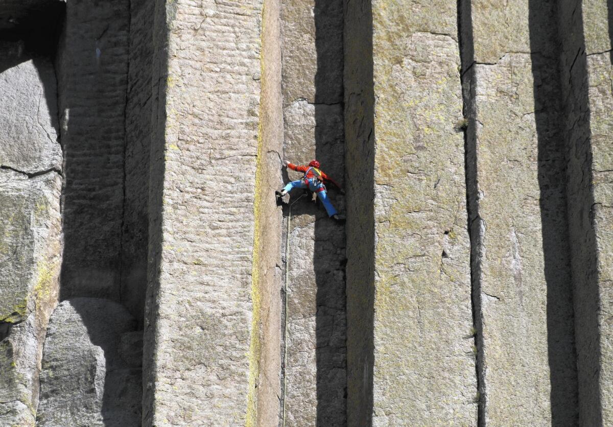 Conrad Anker scales the columns of the Devils Tower National Monument in Wyoming in a scene from the breathtaking new “National Parks Adventure.”