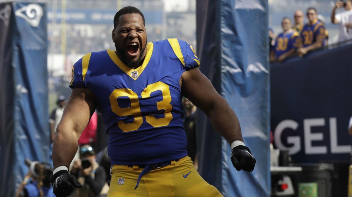 Rams defensive tackle Ndamukong Suh gives a roar to the crowd before a game at the Coliseum against the Green Bay Packers.