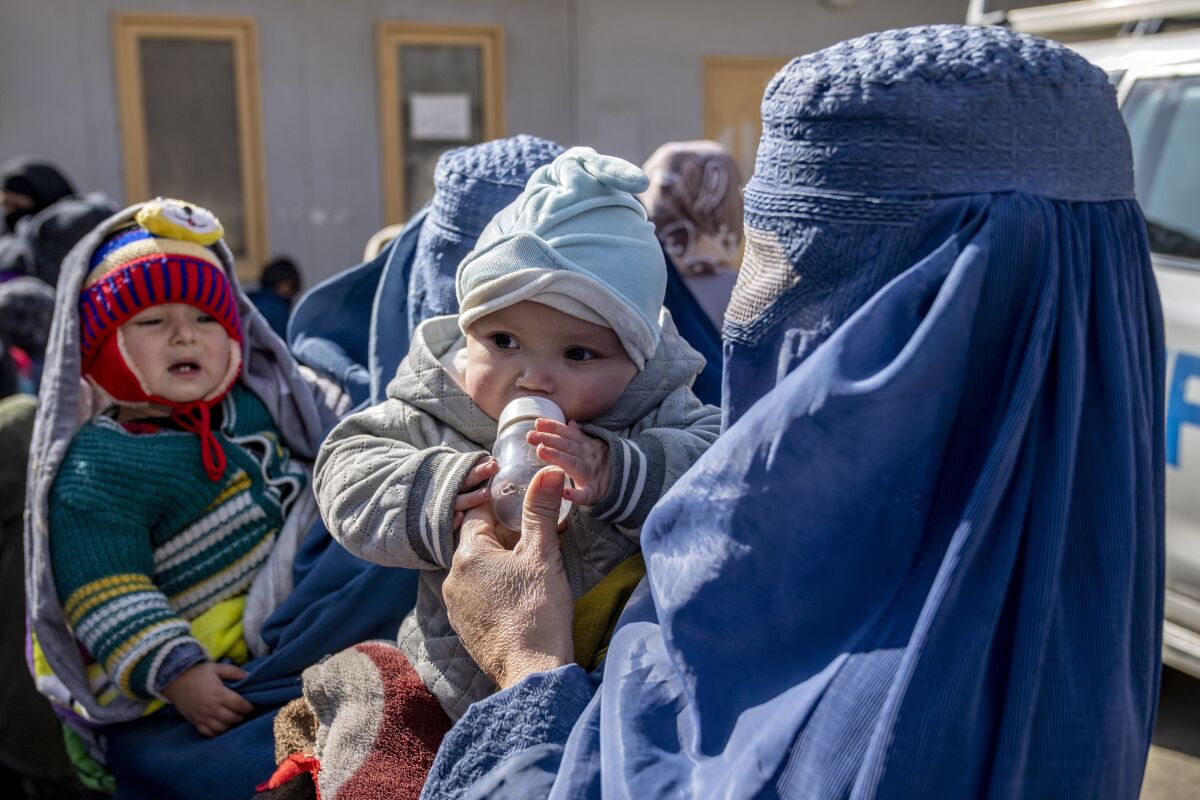Mothers along with babies who suffer from malnutrition wait to receive help and check-up at a clinic that run by the WFP, in Kabul, Afghanistan, Thursday, Jan. 26, 2023. A spokesman for the U.N. food agency says malnutrition rates in Afghanistan are at record highs. Aid agencies have been providing food, education, healthcare and other critical support to people, but distribution has been severely impacted by a Taliban edict banning women from working at national and international nongovernmental groups. (AP Photo/Ebrahim Noroozi)