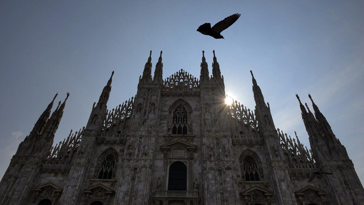 A pigeon flies near the Duomo in Milan, Italy. Turkish Airlines is offering a $618 round-trip fare, but the booking window is short.