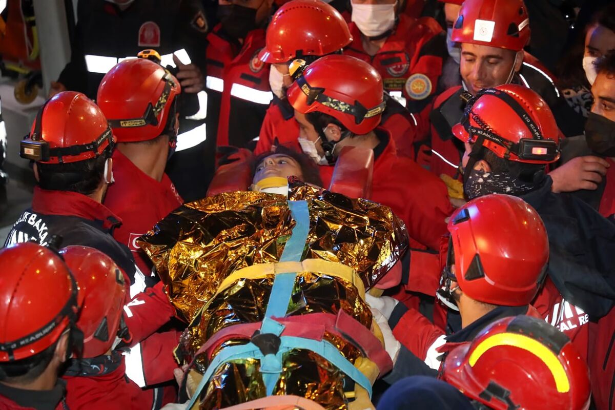 Rescue workers carry 14-year-old Idil Sirin out from the rubble of a collapsed building early Monday.