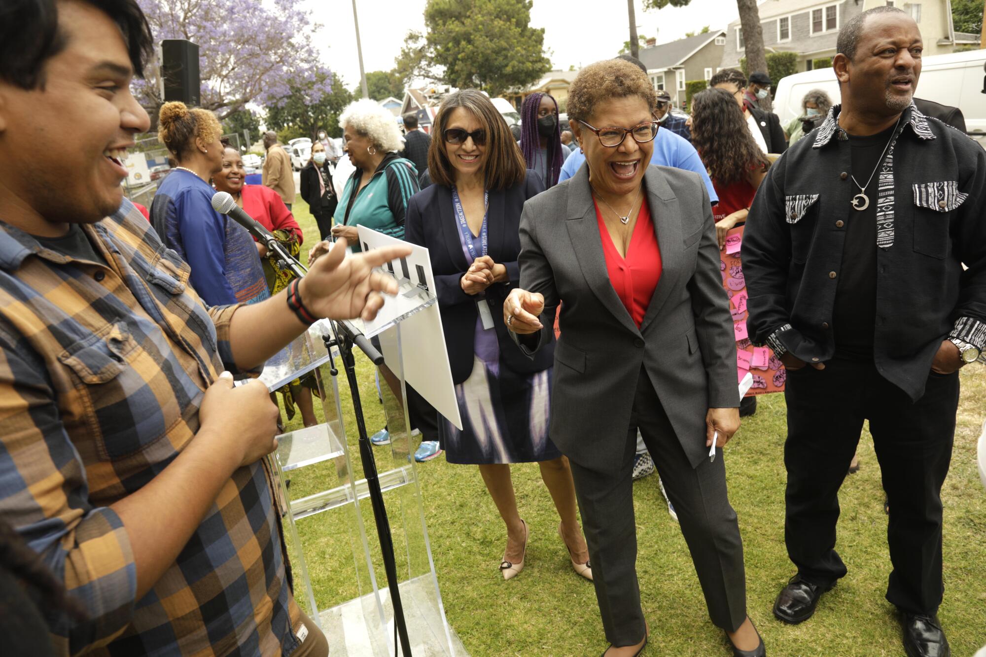 Rep. Karen Bass, center, spends time with supporters at a news conference.