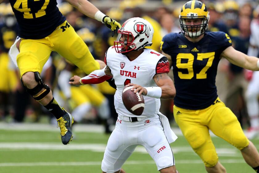 Utah quarterback Kendal Thompson tries to evade the rush of Michigan's defense during their game last weekend.