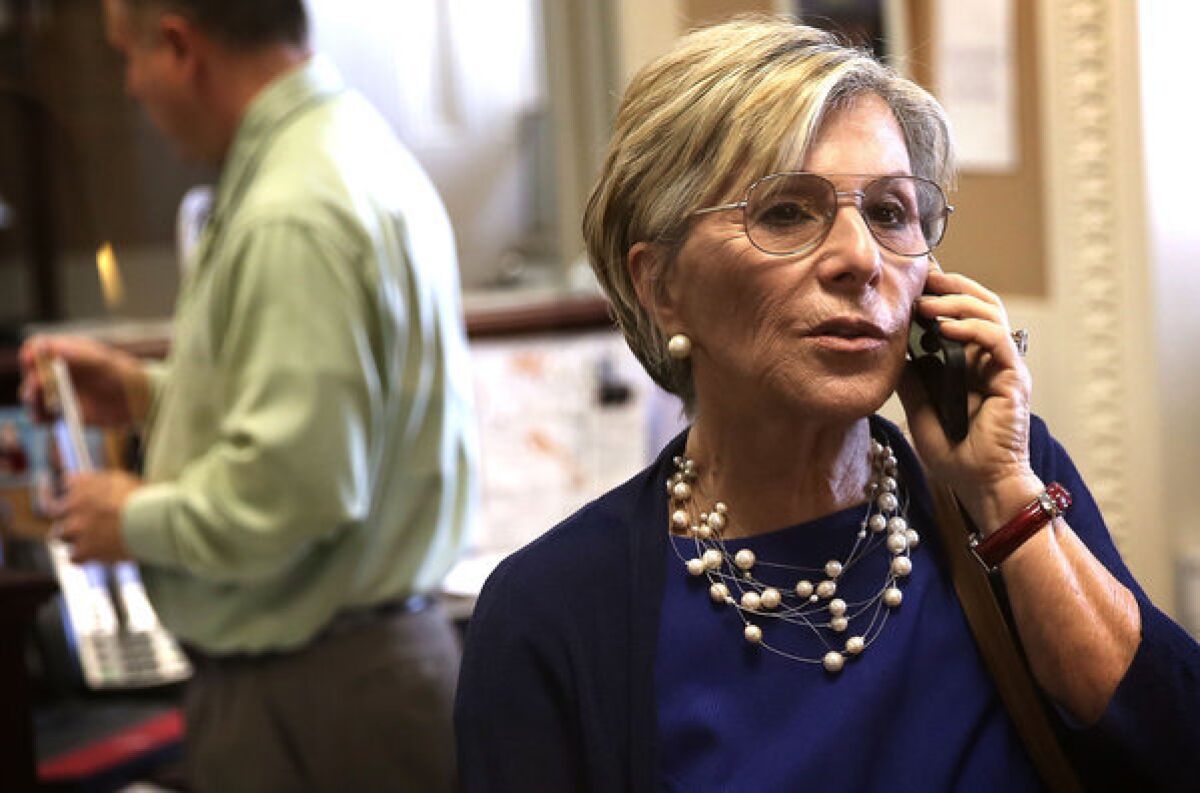 Sen. Barbara Boxer (D-Calif.) gets in a quick call prior to a news conference on Capitol Hill.