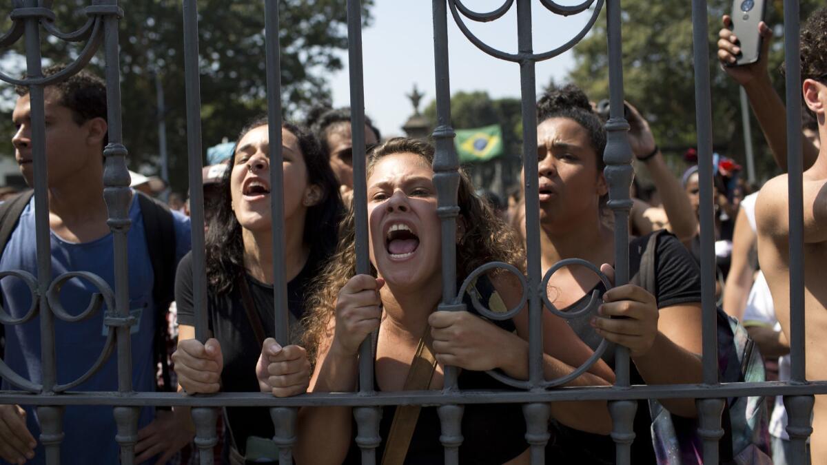 Students and museum employees protest outside Rio de Janeiro's National Museum of Brazil on Sept. 3 after the facility was gutted in a fire the n ight before.