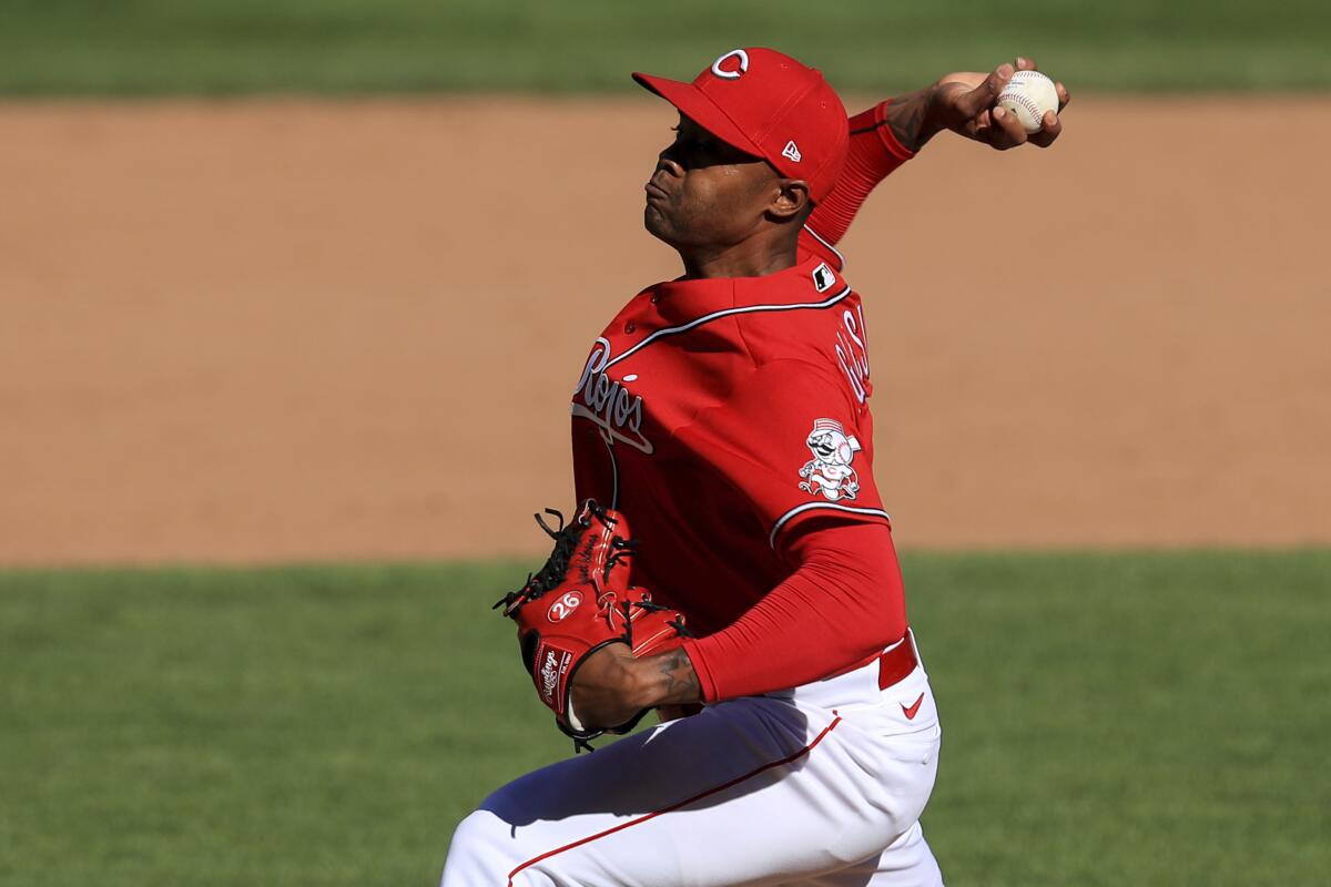Raisel Iglesias pitches from the mound.