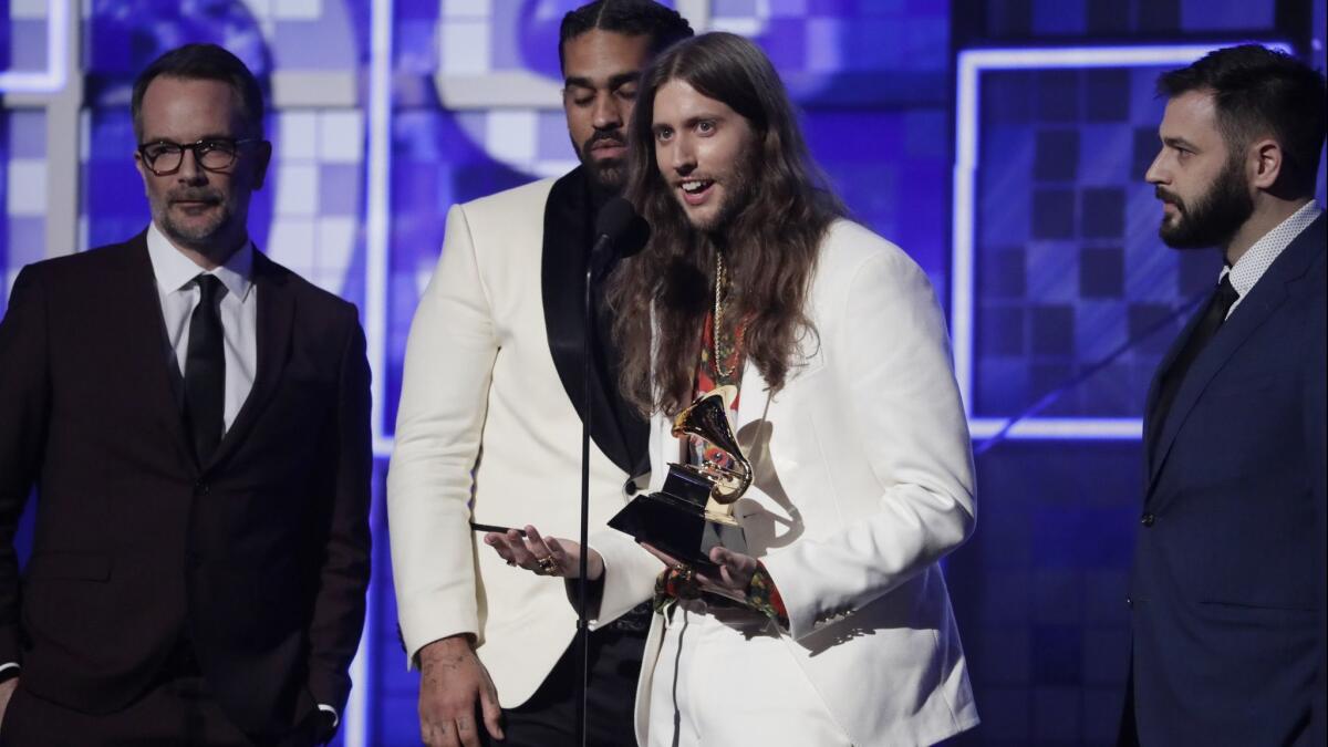 Ludwig Goransson, center, accepts the record of the year award for 'This Is America' at the 61st Grammy Awards.