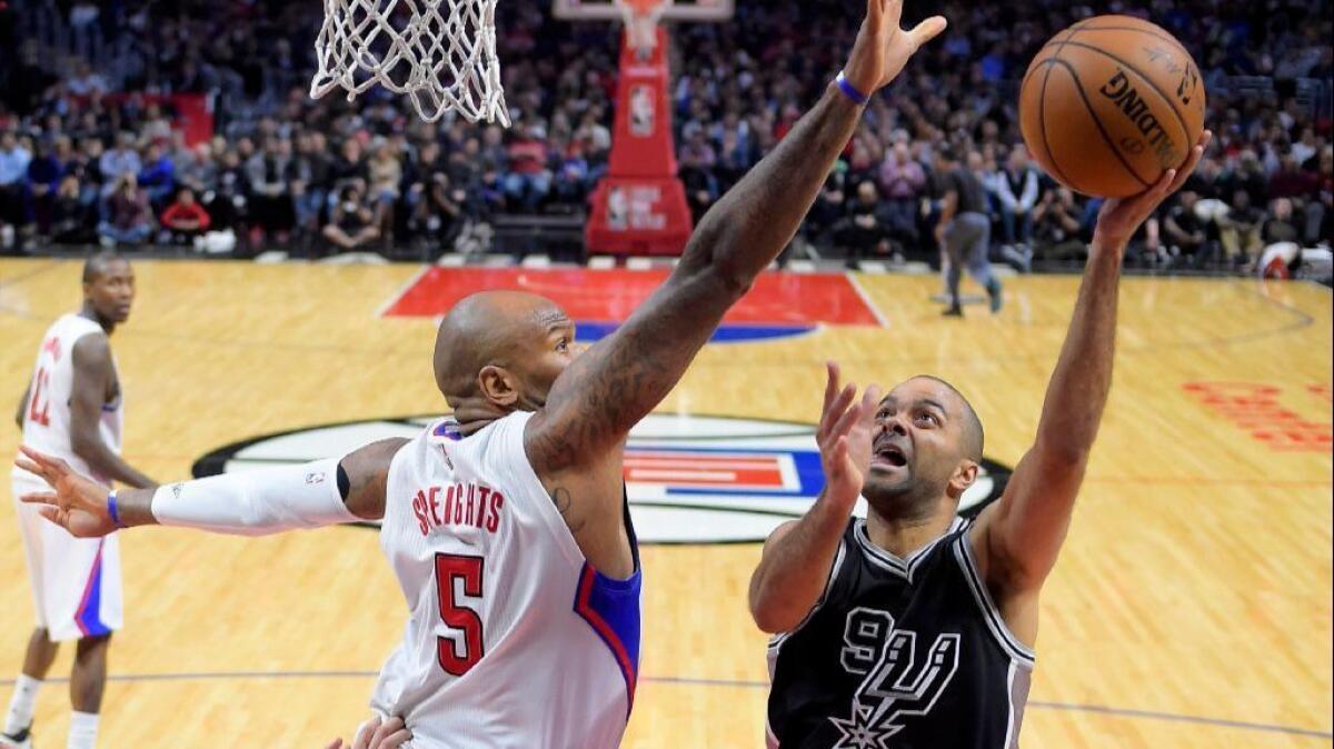 Spurs guard Tony Parker puts up a shot against Clippers center Marreese Speights during the second half of a game on Feb. 24 at Staples Center.