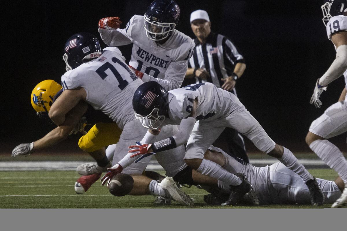 Newport Harbor's Tommy Oltmans recovers a fumble during a nonleague game against Marina on Thursday.