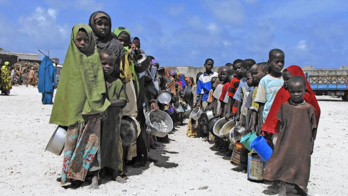 Somali-Americans said some relatives will be unable to afford food, clothing, rent or school fees if it becomes impossible to send money because of fears of illicit fund transfers to terrorists such as the Shabab, an Islamic militant group with ties to Al Qaeda. Above, children from southern Somalia hold their pots as they line up to receive cooked food in Mogadishu, Somalia, in 2011.