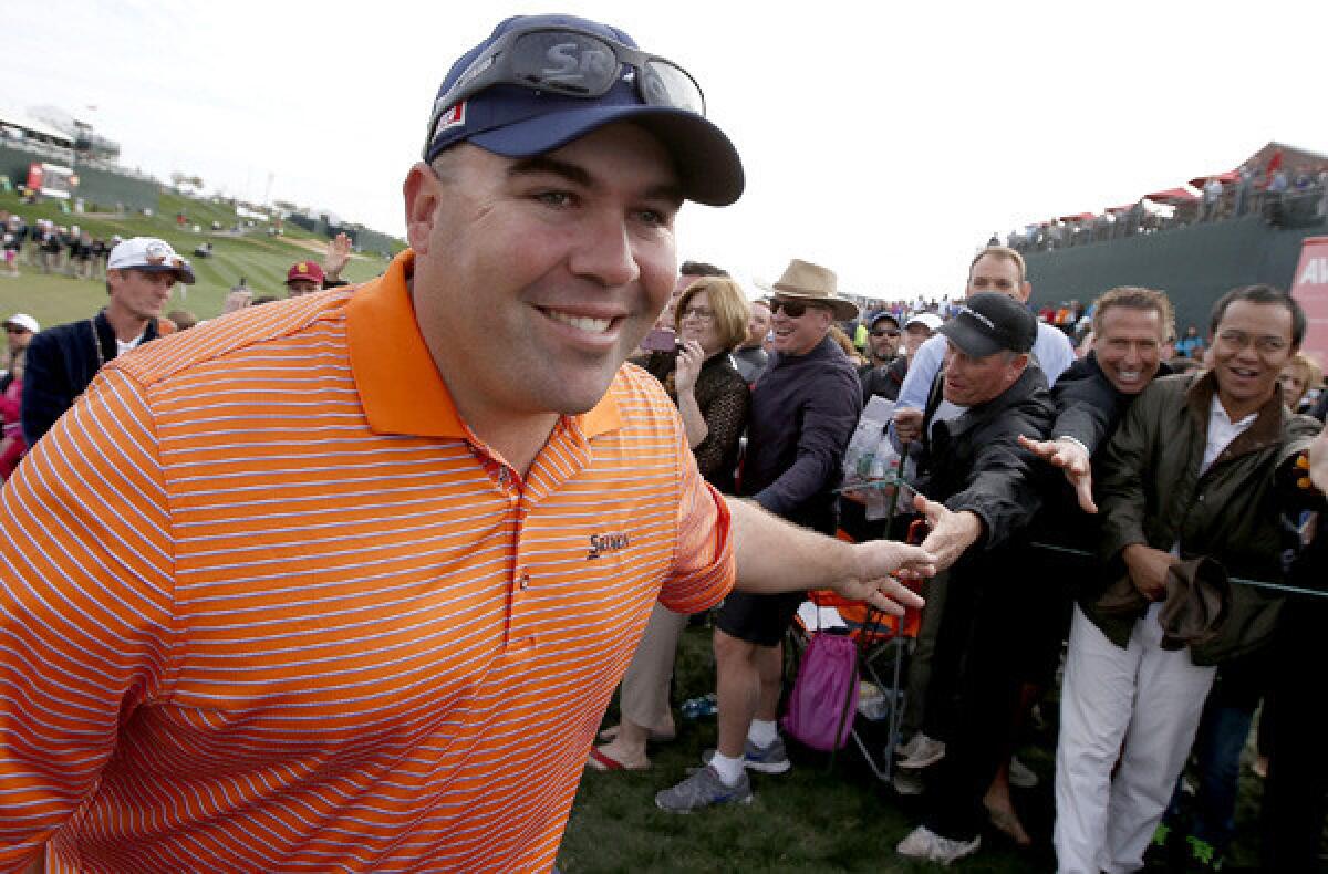 Kevin Stadler is all smiles as he gets handshakes from members of the gallery after winnin the Phoenix Open on Sunday at TPC Scottsdale.