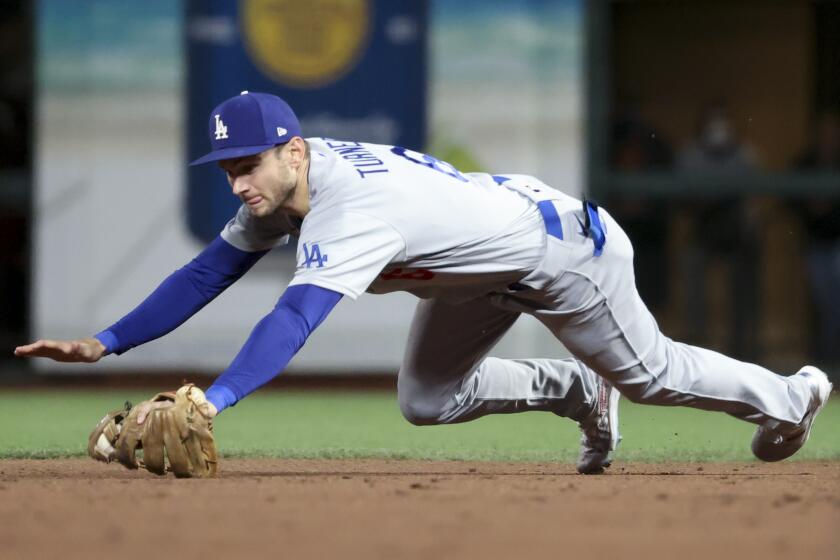 San Francisco, CA - October 09: Los Angeles Dodgers second baseman Trea Turner dives for a ground ball hit by San Francisco Giants' Wilmer Flores during the sixth inning of game two in the 2021 National League Division Series at Oracle Park on Saturday, Oct. 9, 2021 in San Francisco, CA. (Robert Gauthier / Los Angeles Times)