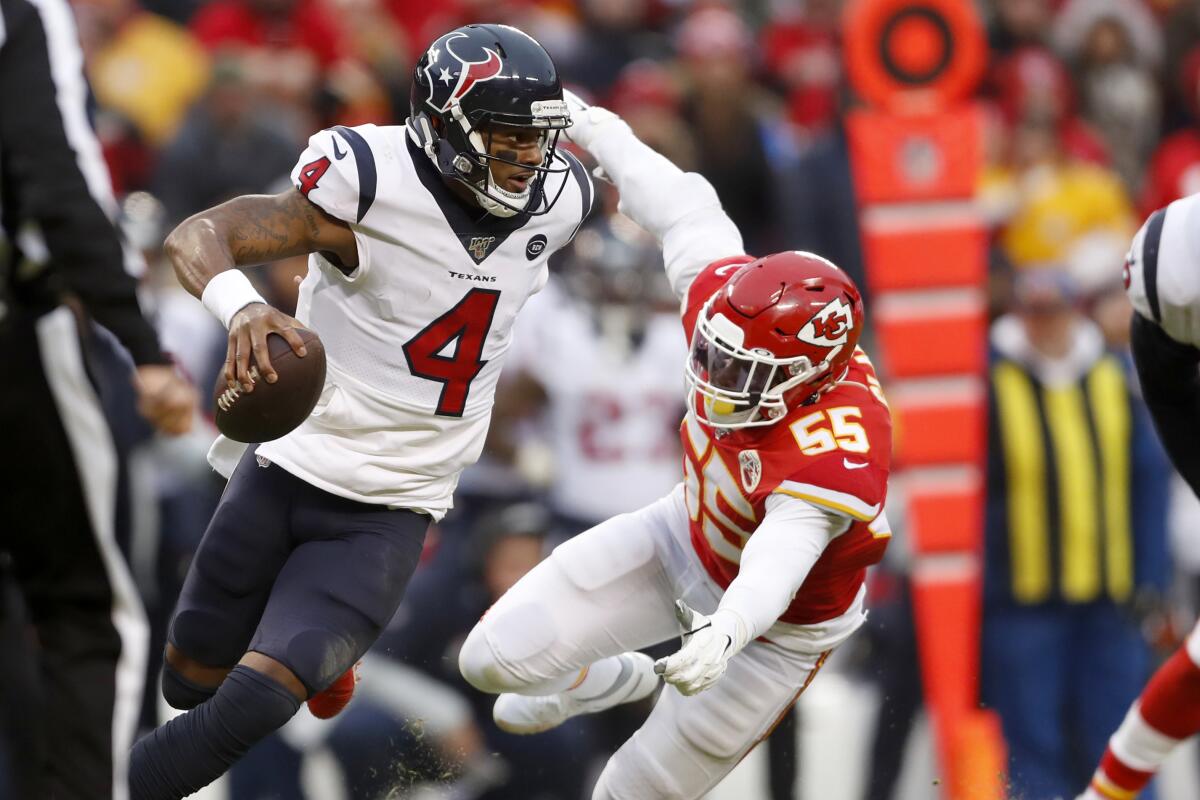 Texans quarterback Deshaun Watson scrambles away from Chiefs defensive end Frank Clark during the second half of an AFC divisional playoff game on Jan. 12.