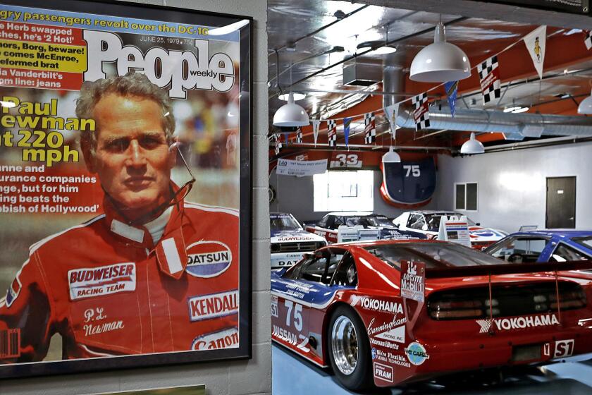 Paul Newman memorabilia at Adam Carolla's garage. The avid car enthusiast has a collection of 10 of Paul Newman's racing cars.
