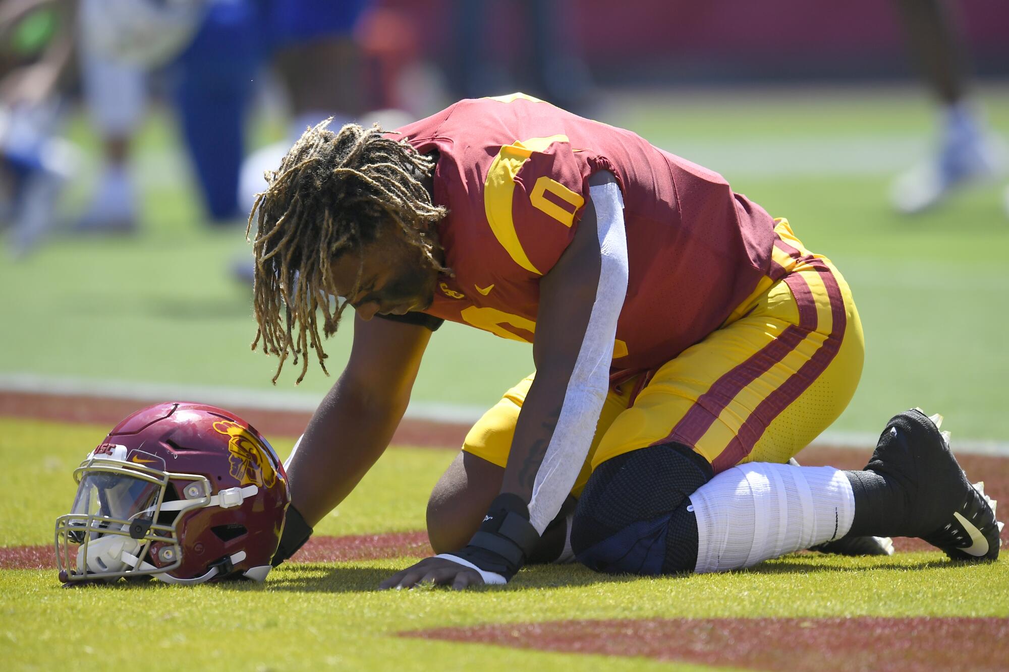 USC defensive lineman Korey Foreman kneels in the end zone before playing San Jose State.