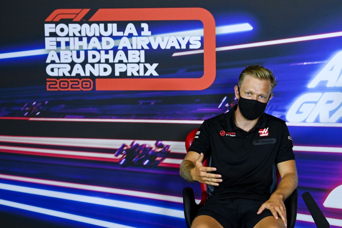 FILE - Haas driver Kevin Magnussen of Denmark attends the press conference ahead of the Abu Dhabi Grand Prix Thursday, Dec. 10, 2020, in Abu Dhabi, United Arab Emirates. Magnussen will make a surprise return to Formula One this season with the same team that fired him a year ago. The Danish driver was rehired Wednesday, March 9, 2022, by Haas F1 to replace Russian driver Nikita Mazepin, who was fired over the weekend following Russia’s invasion of Ukraine.(Mark Sutton, Pool via AP, File)