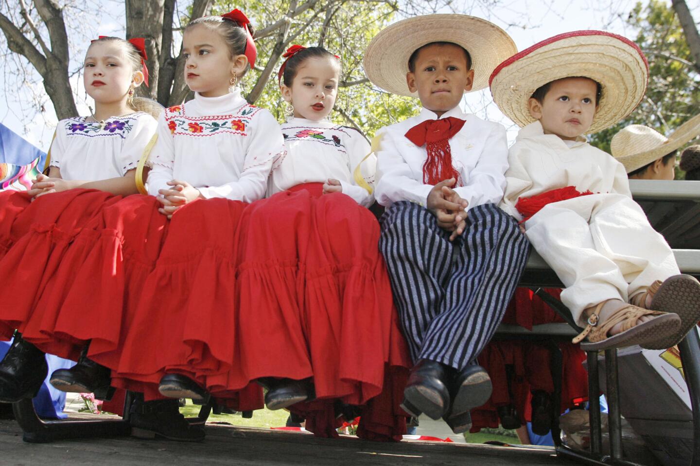 Nicoleta Burkhardt, 5, from left, Cristina Olman, 5, Cristina's twin, Juliana, Adan Villafuertee, 7, and Adan's brother, Santiago, 3, wait before marching at Burbank on Parade, which took place on Olive Ave. between Keystone St. and Lomita St. on Saturday, April 14, 2012.