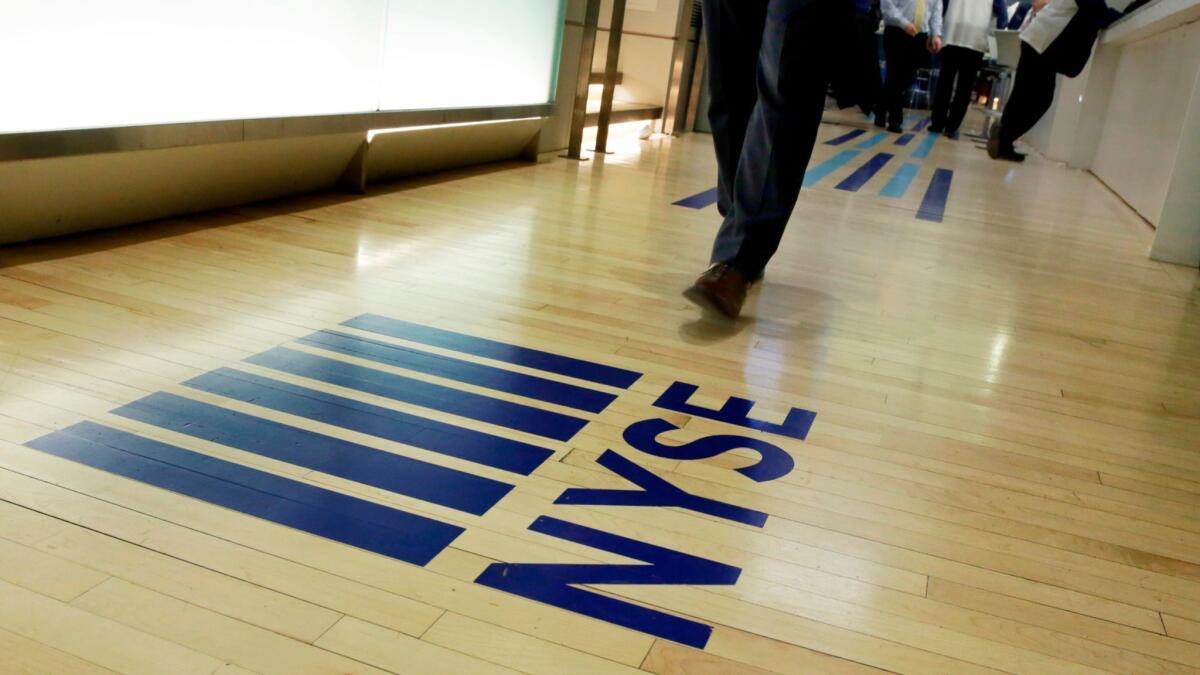 A New York Stock Exchange logo adorns the entrance to the exchange's trading floor.