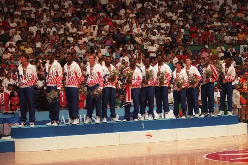 Members of the USA basketball "Dream Team" pose with their gold medals after defeating Croatia, 117–85 to claim the olympic medal in Barcelona, Spain on Aug. 8, 1992.