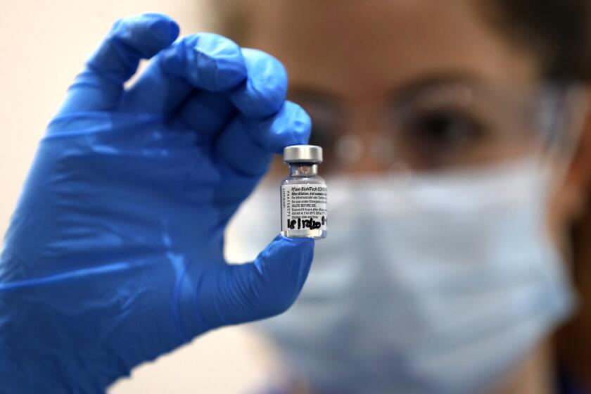 A nurse holds a phial of the Pfizer-BioNTech COVID-19 vaccine at Guy's Hospital in London, Tuesday, Dec. 8, 2020, as the U.K. health authorities rolled out a national mass vaccination program. U.K. regulators said Wednesday Dec. 9, 2020, that people who have a “significant history’’ of allergic reactions shouldn’t receive the new Pfizer/BioNTech vaccine while they investigate two adverse reactions that occurred on the first day of the country’s mass vaccination program. (AP Photo/Frank Augstein, Pool)