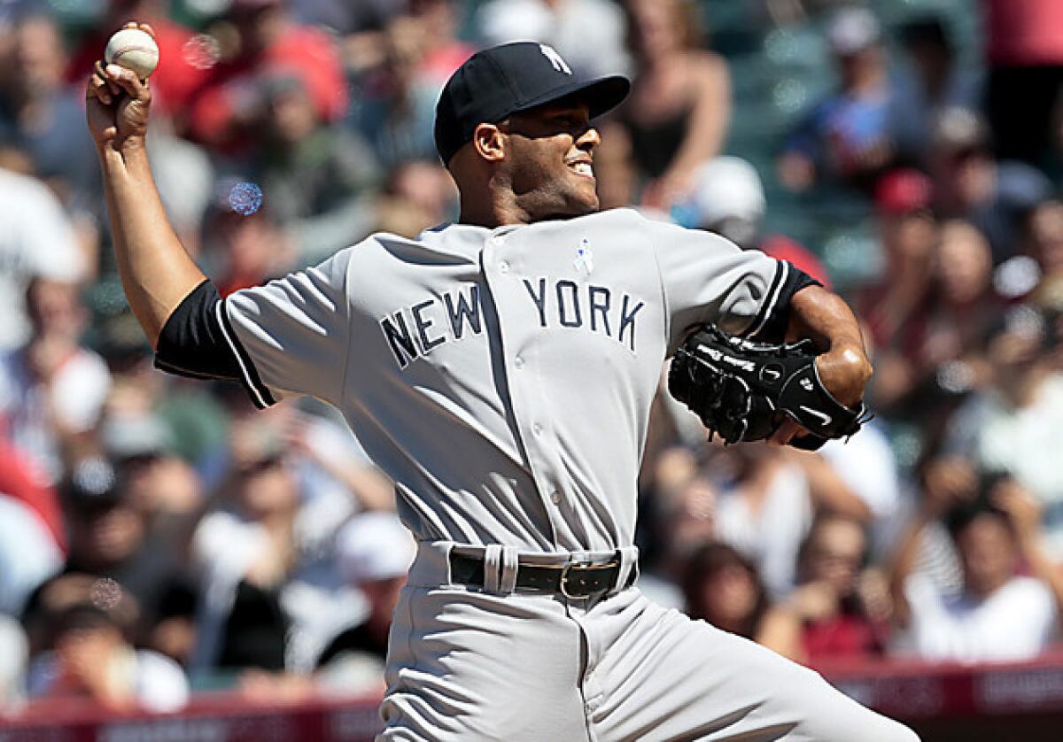 Yankees closer Mariano Rivera struggles in the ninth inning, but still earns a save as the Yankees win 6-5 at Angel Stadium.