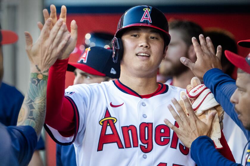 Anaheim, CA - July 21: Angels starting pitcher and two-way player Shohei Ohtani is congratulated.