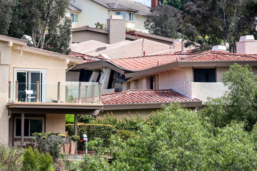 Rolling Hills Estates, CA, Sunday, July 9, 2023 - Cracked foundations and crumbled homes sit along a canyon on Peartree Lane, where dozens of residents were evacuated and structures condemned. (Robert Gauthier/Los Angeles Times)