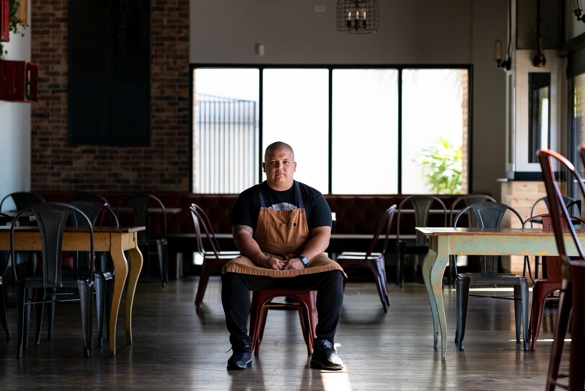 Brad Wise, executive chef and partner in Trust Restaurant Group, is seated in his Cardellino restaurant in Mission Hills, which will be reopening in the coming weeks.