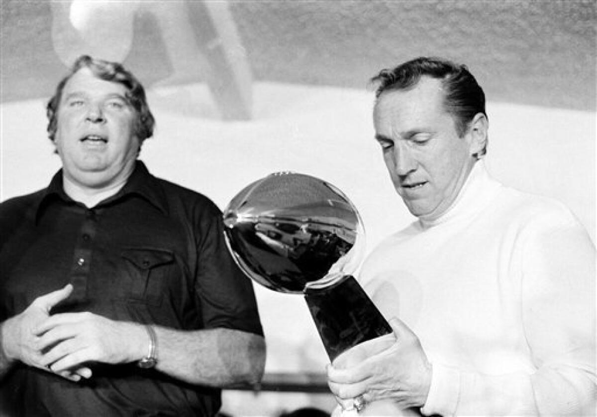 FILE - In this Jan. 9, 1977, file photo, Oakland Raiders coach John Madden, left, talks as team owner Al Davis holds the Vince Lombardi Trophy after the Raiders' 32-14 victory over the Minnesota Vikings in Super Bowl XI in Pasadena, Calif. Davis, the Hall of Fame owner of the Raiders known for his rebellious spirit, has died, the team announced on Saturday, Oct. 8, 2011. (AP Photo/File)