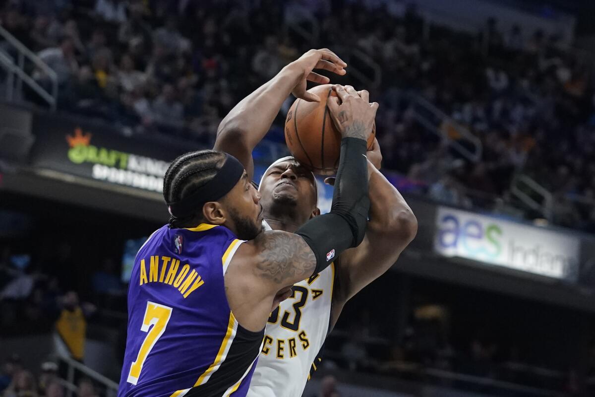 Indiana Pacers' Myles Turner is fouled by Lakers' Carmelo Anthony.