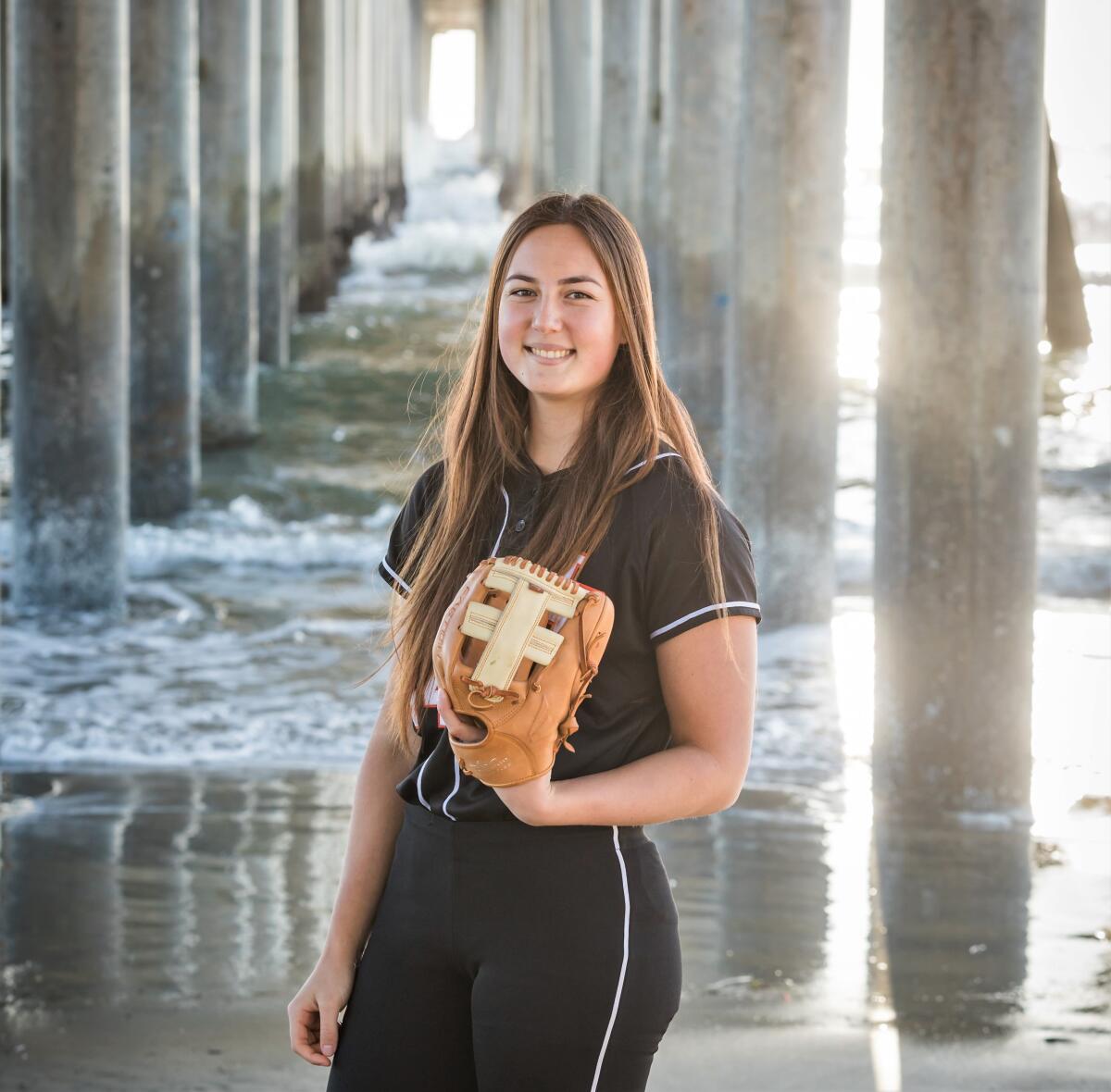 Huntington Beach High softball pitcher Zoe Prystajko poses for a photo at the pier.