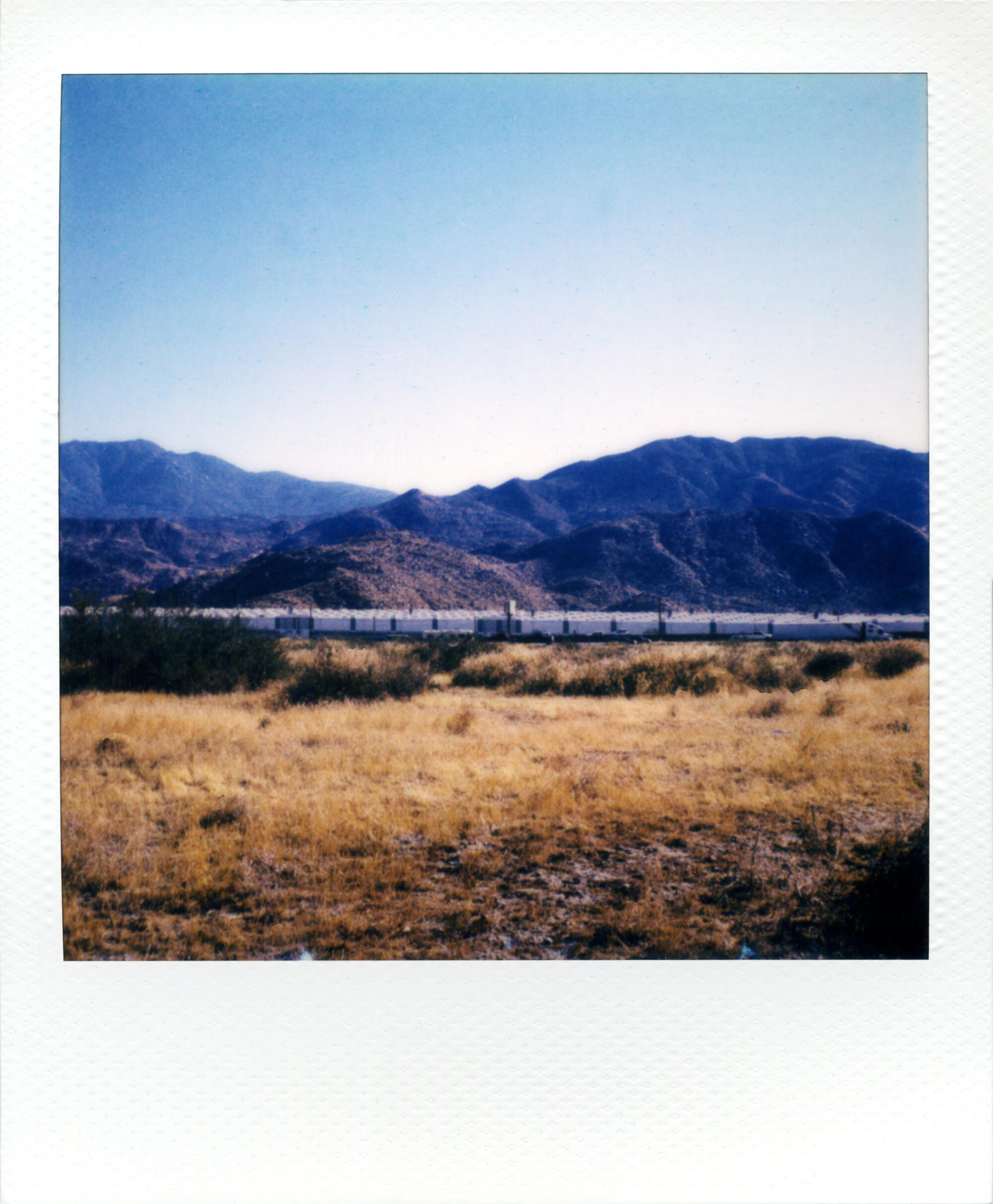 Liner Notes polaroid of shipping containers in the desert