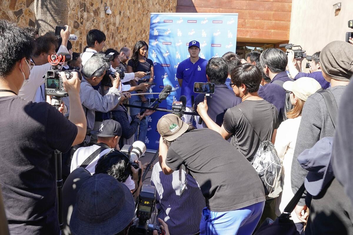 Shohei Ohtani addresses the media about his surprise marriage announcement on Thursday at Camelback Ranch in Phoenix.