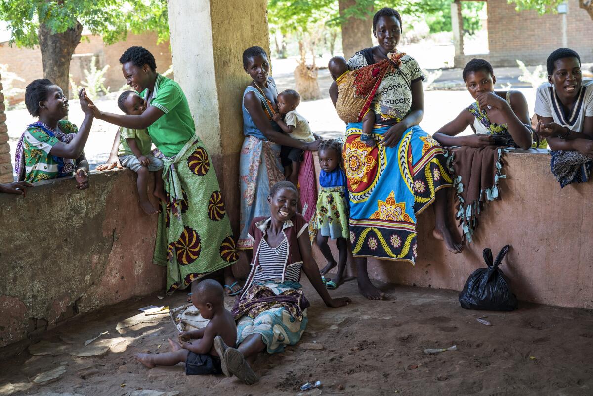 Mali residents wait to have their young children become test subjects for the world's first vaccine against malaria