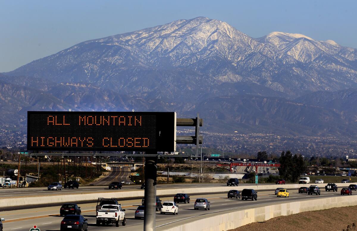 A Caltrans sign along the 210 Freeway warns of closed roads into the San Bernardino Mountains during a law enforcement search in 2013.