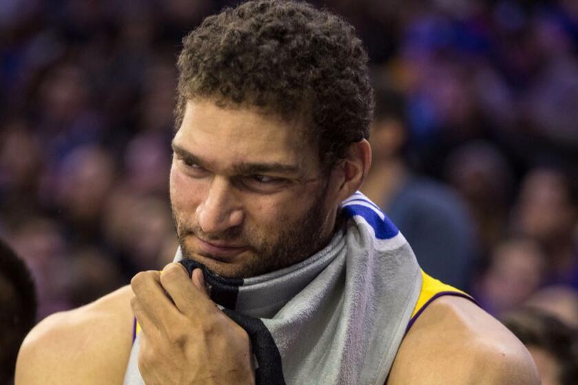 Los Angeles Lakers Brook Lopez looks on from the bench during the second half of an NBA basketball game against the Philadelphia 76ers, Thursday, Dec. 7, 2017, in Philadelphia. The Lakers won 107-104. (AP Photo/Chris Szagola)