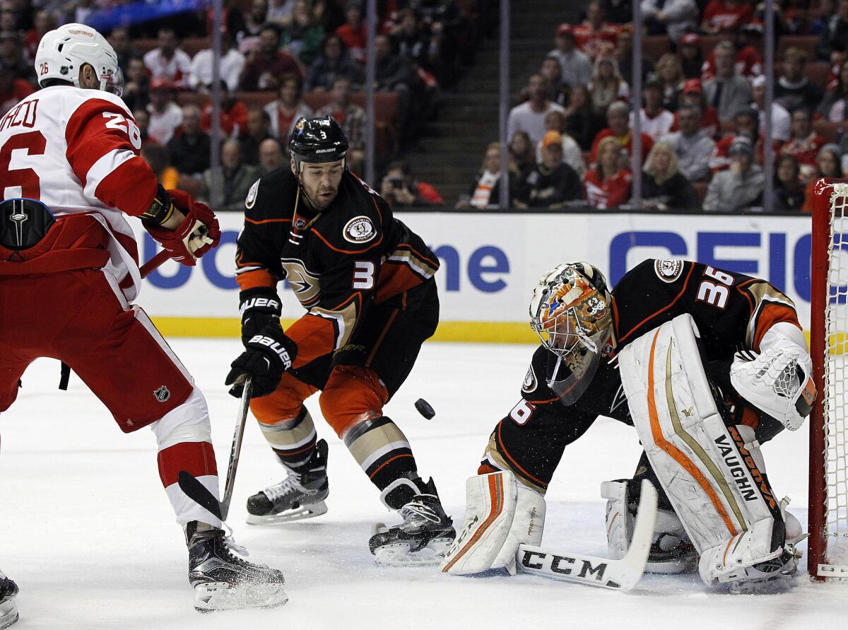 Ducks goalie John Gibson (36) blocks a shot by Red Wings right wing Tomas Jurco (26) with defenseman Clayton Stoner (3) looking on during the first period.