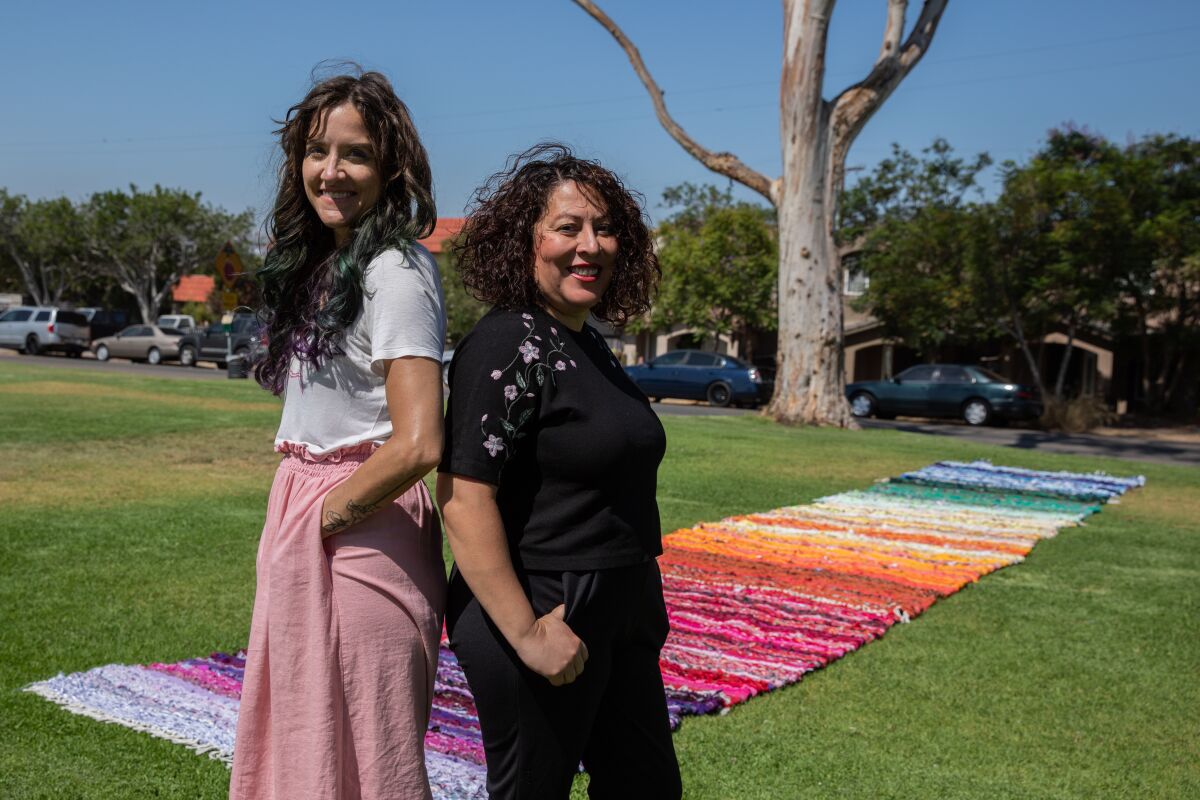 Artists Sheena Rae Dowling (left) and Yvette Roman (right) pose for a portrait at San Ysidro Community Park San Diego.