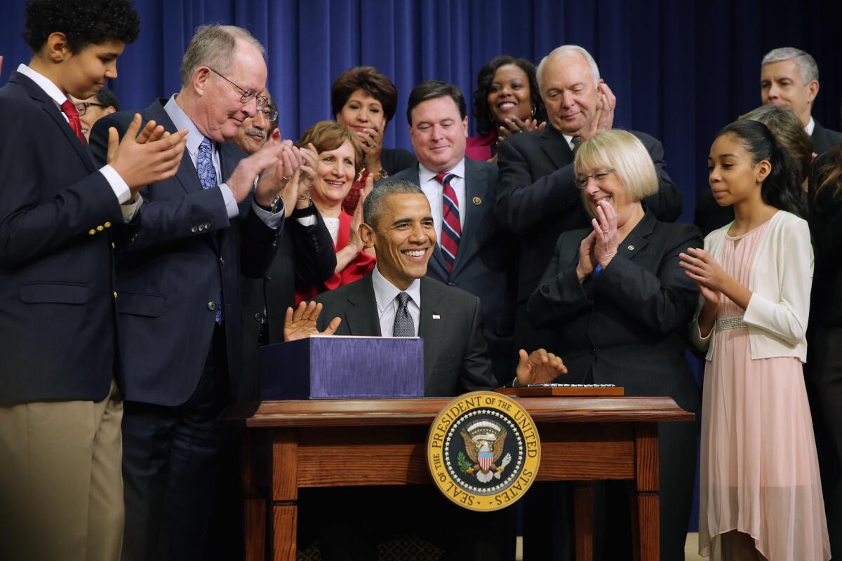 Members of Congress, education leaders and students applaud after President Barack Obama signs the Every Student Succeeds Act in Washington, D.C., in December.