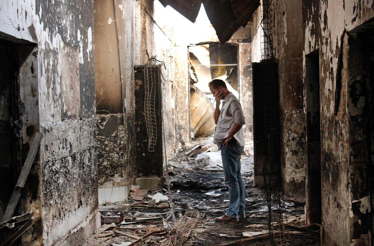 An employee of Doctors Without Borders walks inside the charred remains of the organization's hospital in Kunduz, Afghanistan, on Oct. 16 days after it was hit by a U.S. airstrike.